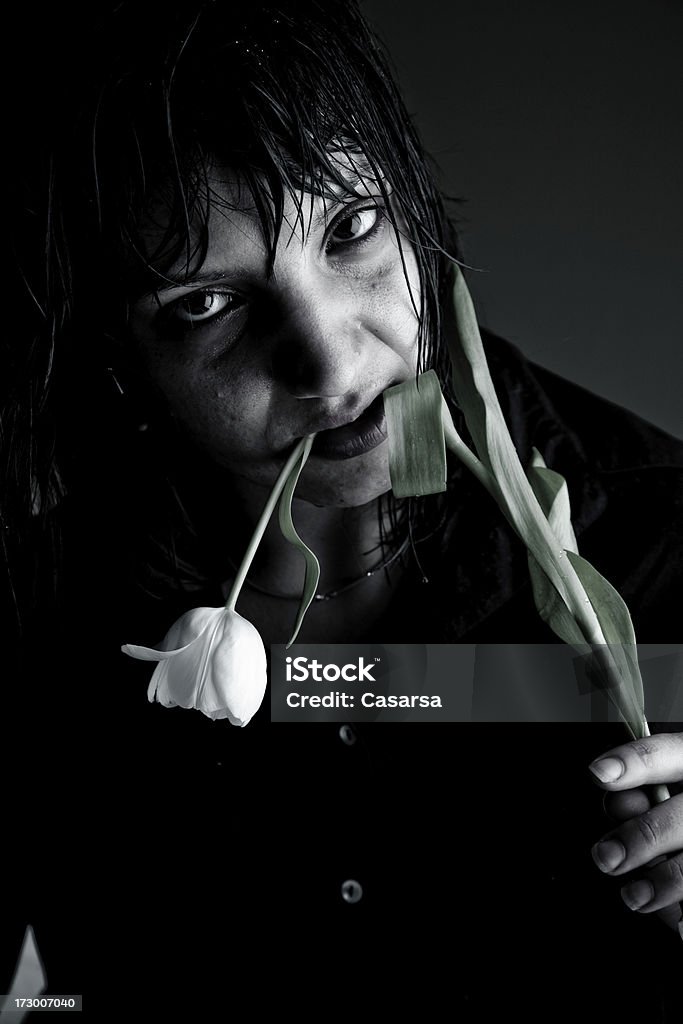 Don't bring me flowers Angry look of a gilr biting a flower 20-24 Years Stock Photo