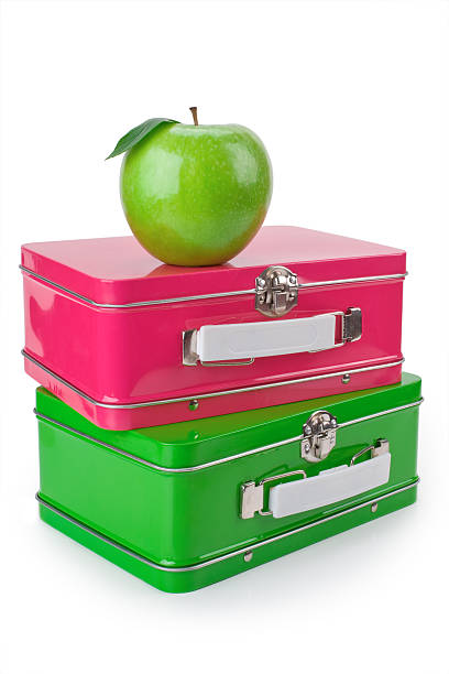 Ready for school with a shiny apple and lunchboxes stock photo