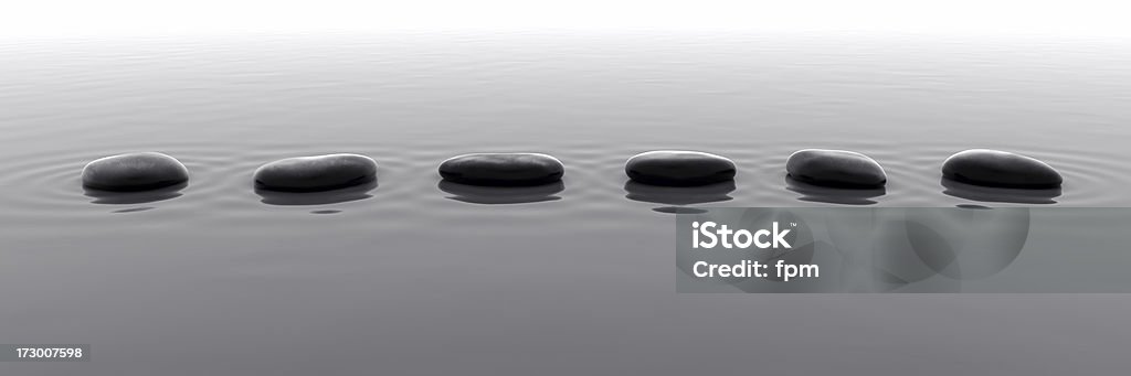 Pebbles in Water V Studio-like royalty free 3d rendering of a row of shiny black pebbles. Stepping Stone Stock Photo