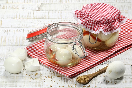 home canned pickled eggs on wooden table