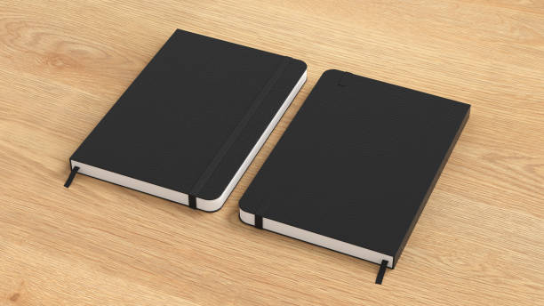 Black cover notebook mockup on wooden background