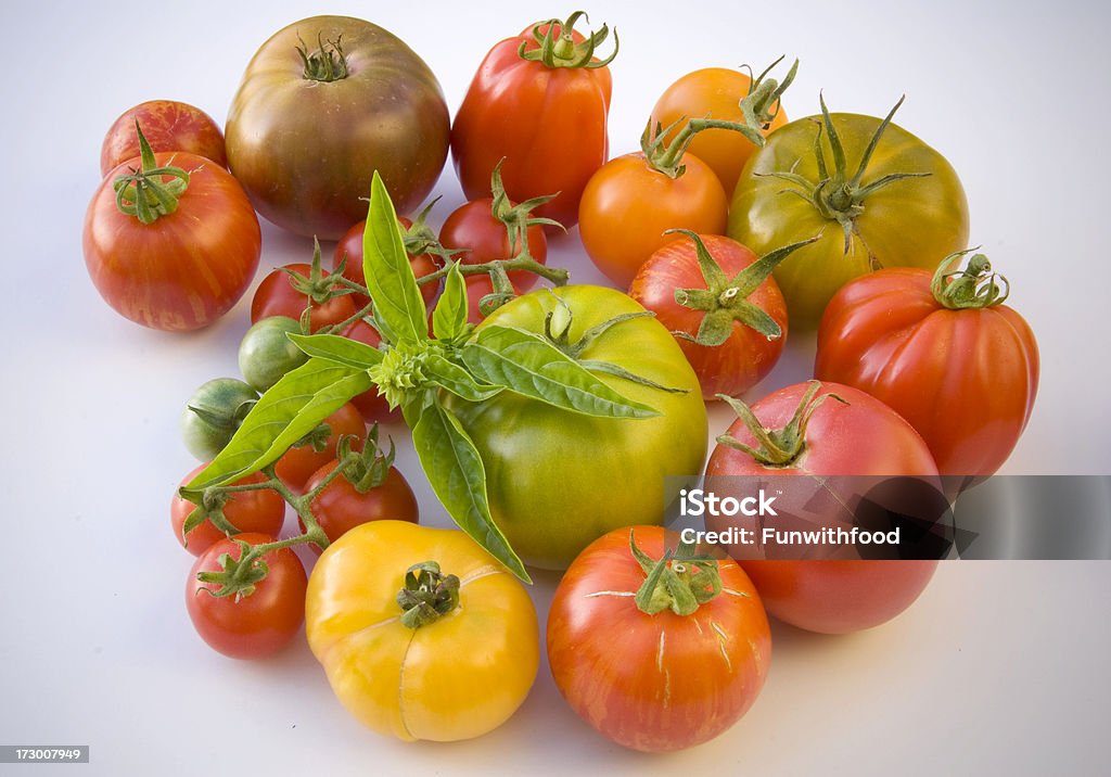 Assorted Heirloom Tomatoes Vegetables Background, Organic Homegrown Produce Assortment of freshly picked organic homegrown heirloom tomatoes. (SEE LIGHTBOXES BELOW for many more fresh vegetables, fruit, fresh summer produce, cooking & other food photos...) Basil Stock Photo