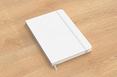 White cover notebook mockup on wooden background