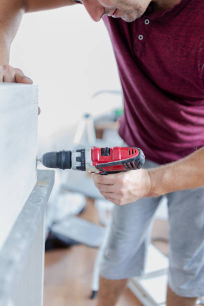 istock Carpenter installing kitchen chest of drawers by using electrical drill. Home renovation concept. 1730081531