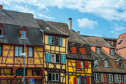 17. 07. 2023 Colmar, Alsace, France, yellow facades of traditional half-timbered houses and architectural details in old town Colmar.