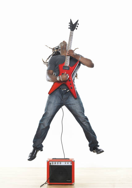 istock Man playing electric guitar and jumping 173008390