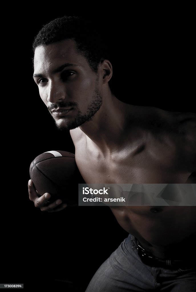 Football player "Football player on black background, dramatic lighting." 20-24 Years Stock Photo