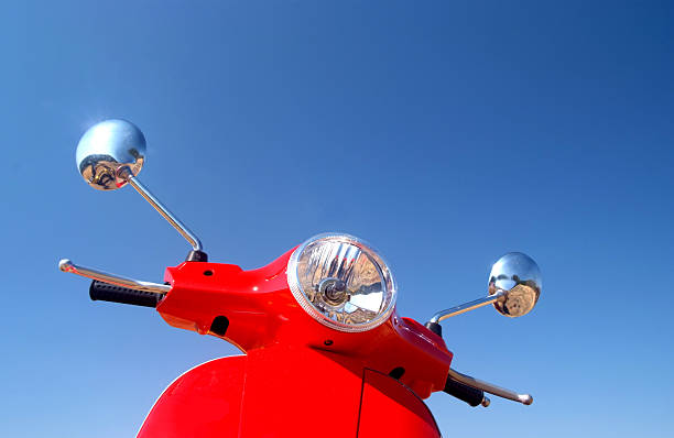 Retro Vespa Red retro vespa against blue summer sky moped stock pictures, royalty-free photos & images