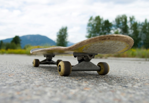 Riderless skate board in an abandoned  parking lot
