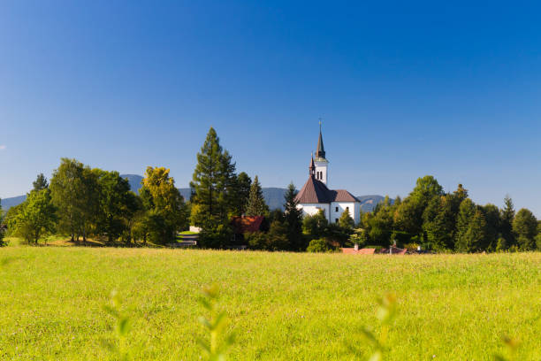 istock Mountain landscape with a small village church 1730092881
