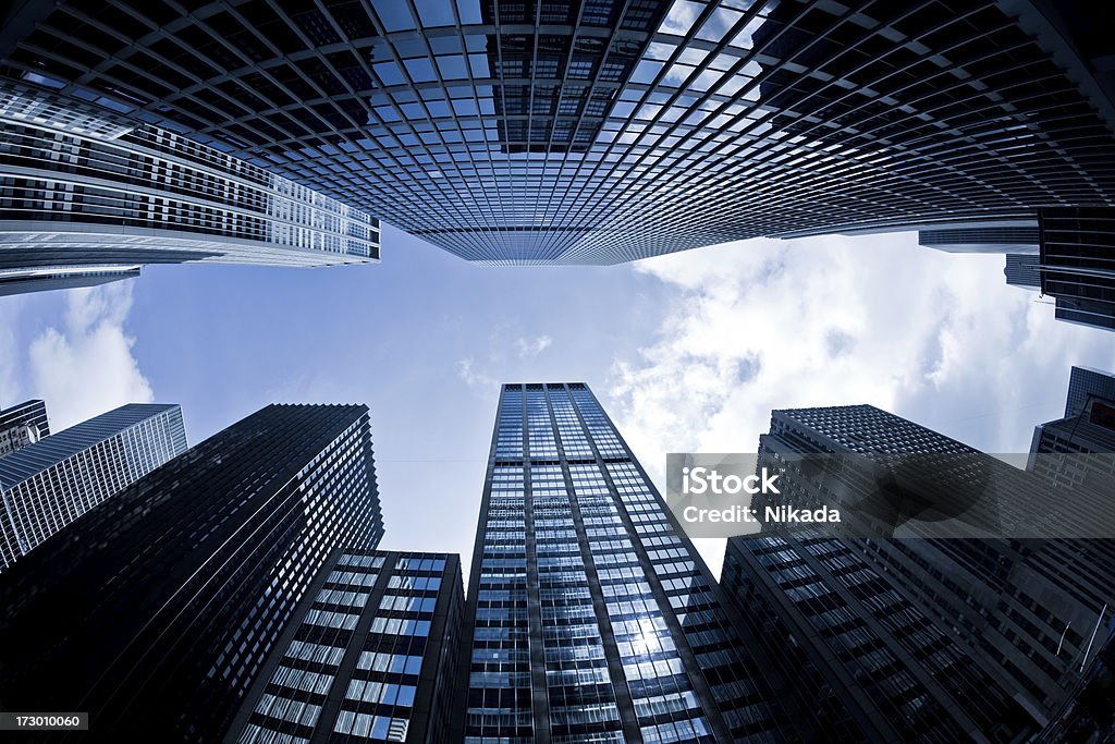 Business tower in NYC "Low angle view of different corporate buildingsNew York City, USAfisheye lens used" Architecture Stock Photo