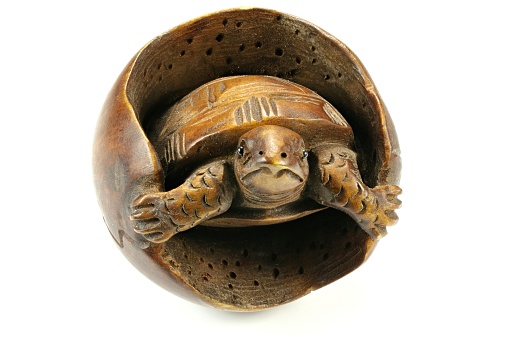 antique Japanese netsuke turtle made of boxwood isolated on white background