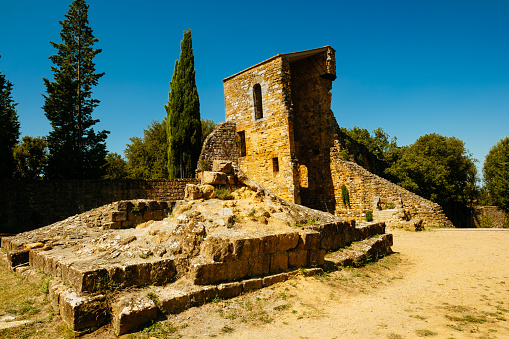 Ancient ruin called Torre del Cassero in the village of San Quirico d’Orcia, Tuscany, Italy. The tower was reduced in height by the retreating German Army in 1944.