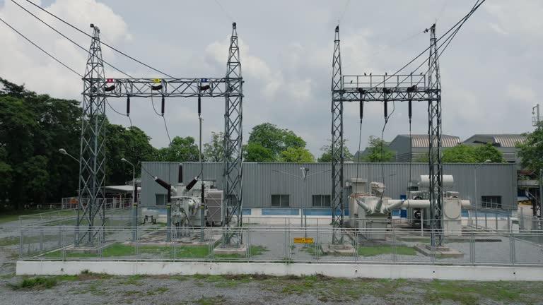 dolly scene of power plant and high voltage electric pole station for supply to industry.