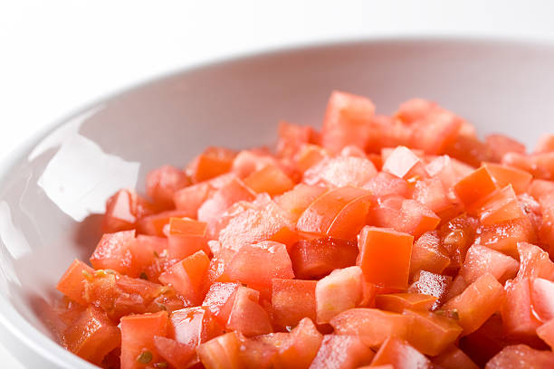 diced tomatoes in bowl stock photo