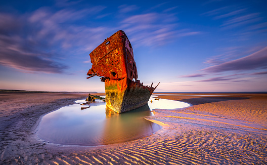 Ireland Famous Landscape shipwreck on the beach shipwreck boat abandoned stand on beach or Shipwreck off the coast Shipwrecked off the coast of Ireland