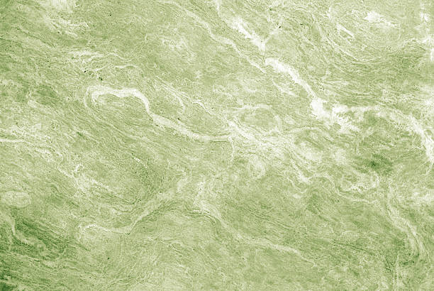 Colorful,textured, granite or marble wall with green coloring.  Great background.