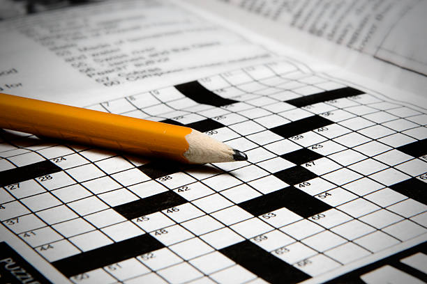 Crossword Puzzle A pencil and a crossword puzzle. crossword stock pictures, royalty-free photos & images