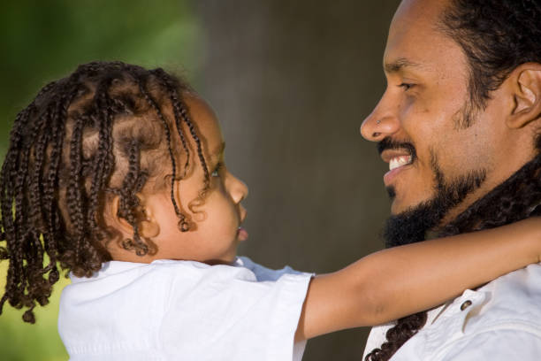istock Side view of father and son looking at each other 173013081