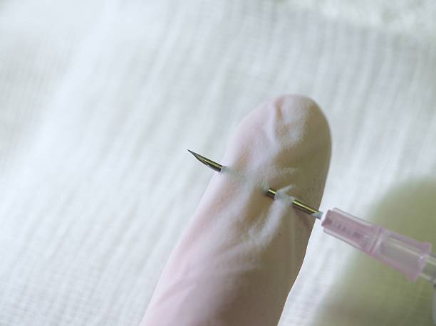Needle Stick Needle through glove      needle plant part stock pictures, royalty-free photos & images