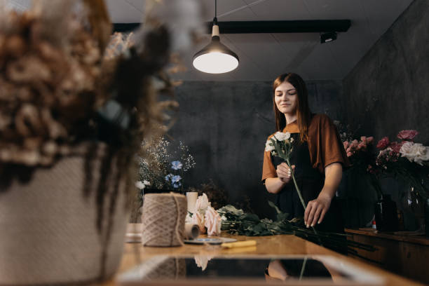 istock Florist with bouquet of roses at work. 1730143639