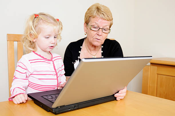 istock grandma and grandaughter using laptop 173014703