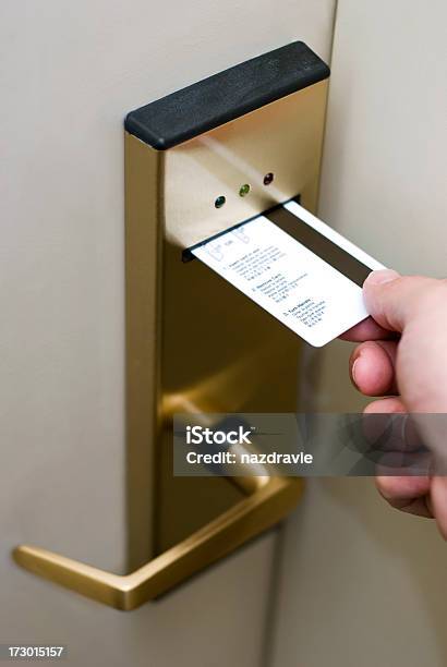 Male Hand Inserting Card Key Into Electronic Hotel Door Lock Stock Photo - Download Image Now