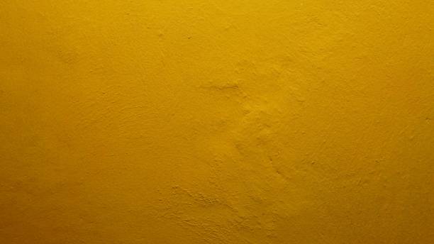 istock The texture background of the wall with yellow paint has a rough surface 1730151662