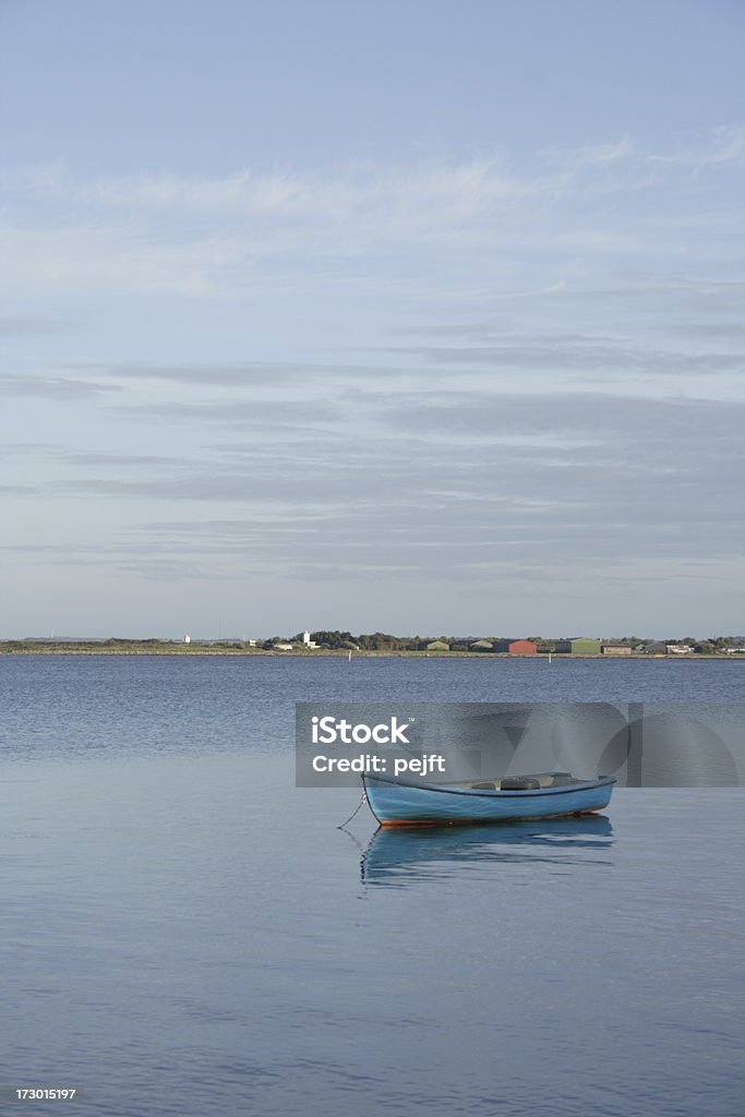Dinghy - a rowing boat at anchor in Limfjorden Anchoring rowing boat in the fjord Limfjorden by the town Struer in Denmark. Anchored Stock Photo