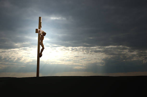 istock Christ on the Cross and dark sunset 173015783