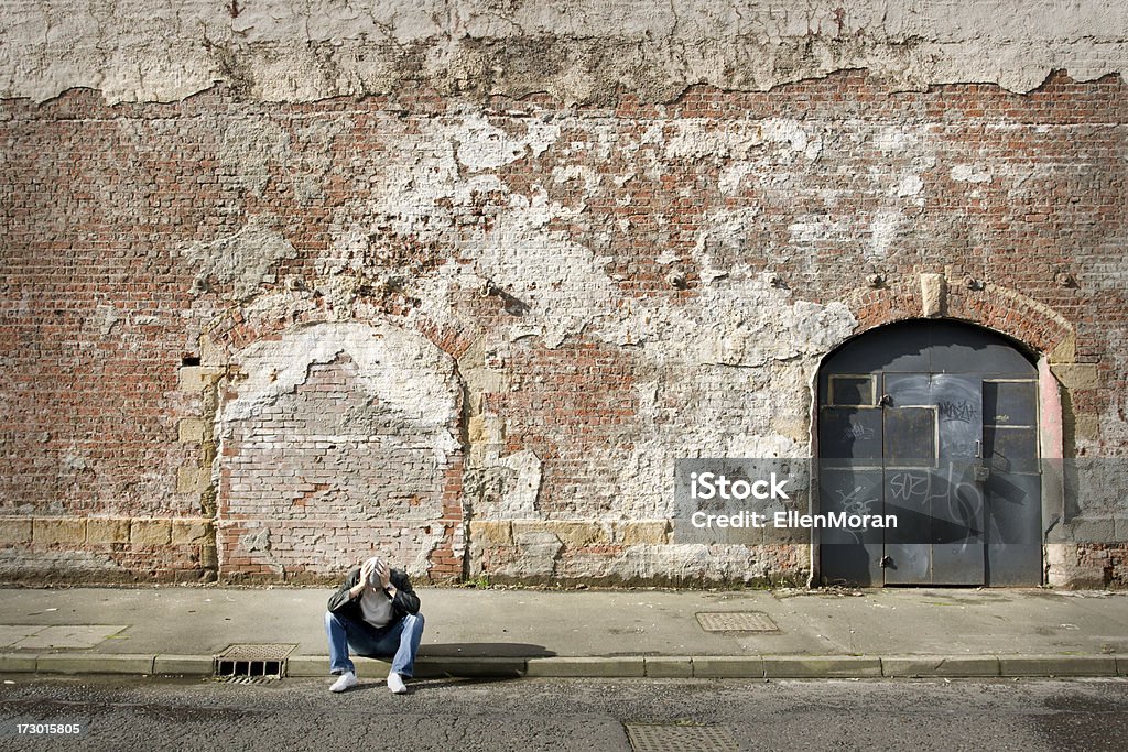 Lonely Man Lonely man sitting on curb Abandoned Stock Photo