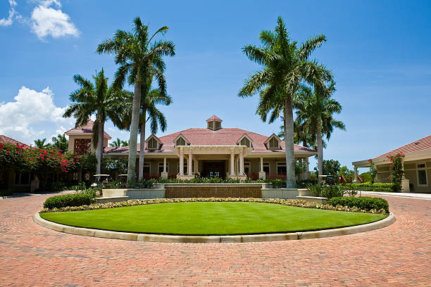 Impressive Clubhouse With Brick Driveway Florida Golf Community Wide Angle Clubhouse at a golf community. country club stock pictures, royalty-free photos & images