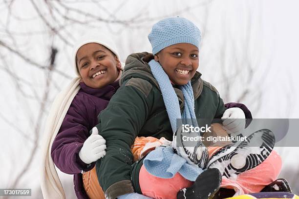 Kids Sitting On A Sled Stock Photo - Download Image Now - Multiracial Group, Snow, Winter