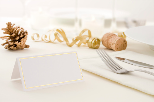 A christmas themed table setting with blank place card.