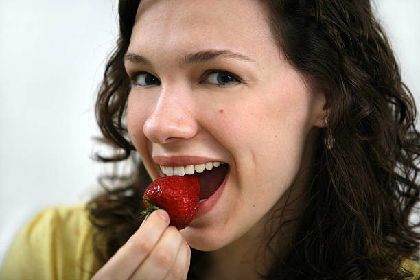 istock girl enjoying strawberry 173017823