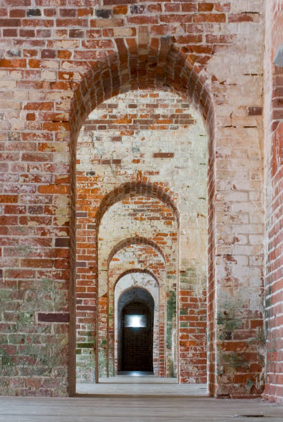 istock Long Brick Hallway With Arched Doorways 173018456