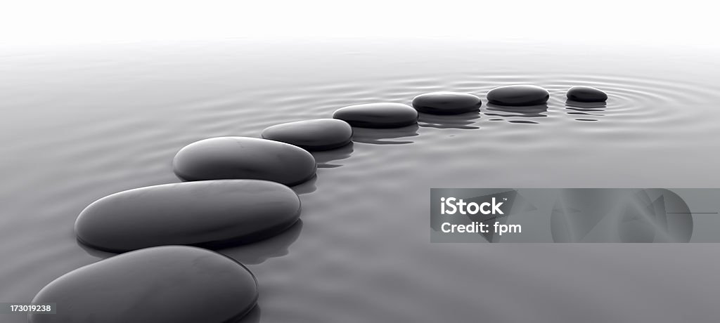 Pebbles in Water I Studio-like royalty free 3d rendering of a row of shiny black pebbles. Stepping Stone Stock Photo