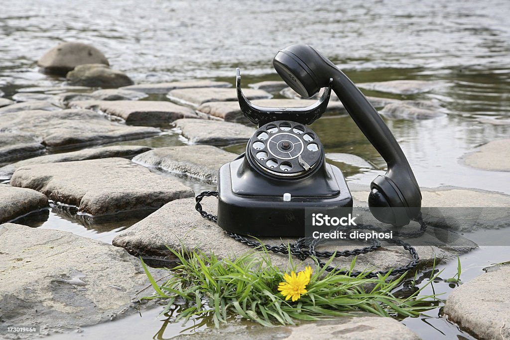 Green phone antique phone placed on the water Ancient Stock Photo