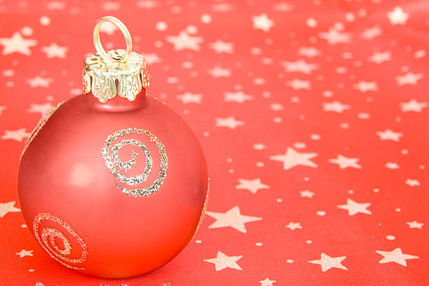 istock Red and gold Christmas bauble on starry background 173020706