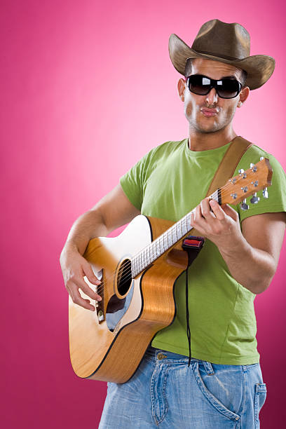 istock young country singer with guitar  portrait  pink background 173020748
