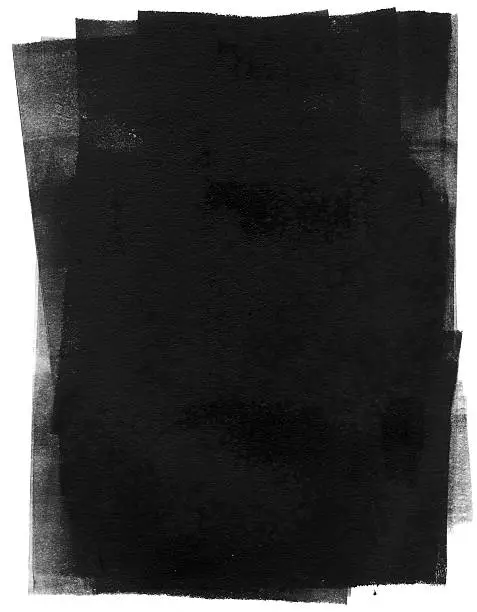 Photo of Black ink rolled out onto a white background