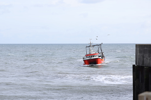 istock Fishing boat entering West Bay harbour 1730208795