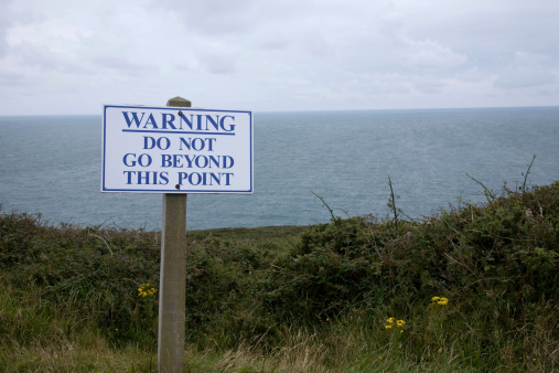 Warning sign near to a cliff edge
