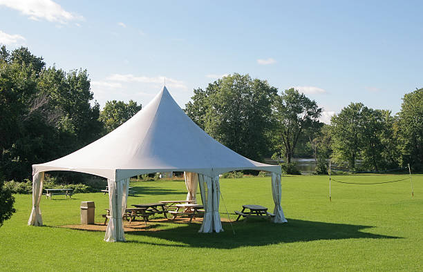 Small Marquee Tent with picnic tables in a park stock photo