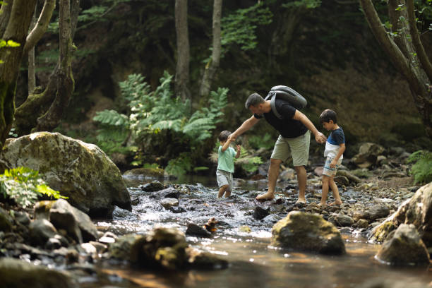 istock Father and boys hiking in the forest 1730215130