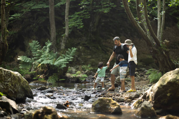 istock Father and boys hiking in the forest 1730216191