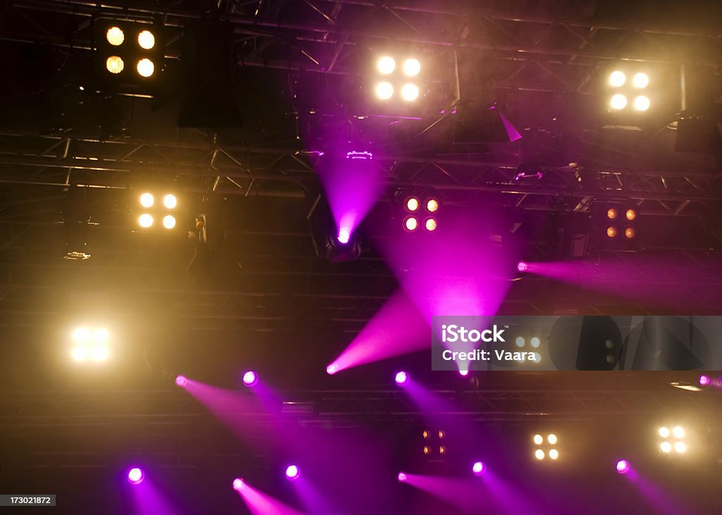 Purple Stage Lights Purple moving lights strike through the fog in a rock concert. Arts Culture and Entertainment Stock Photo