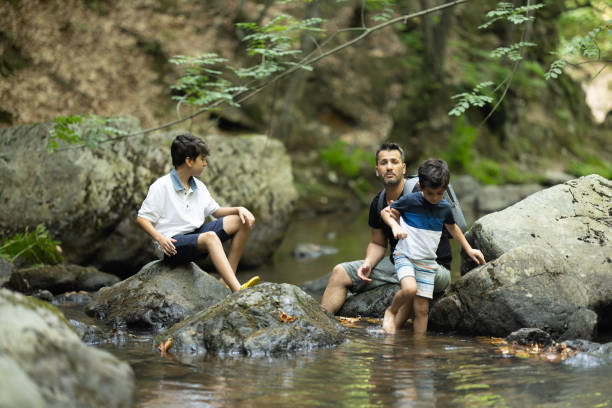 istock Father and boys hiking in the forest 1730218847