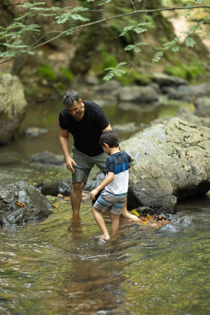 istock Father and boys hiking in the forest 1730218850