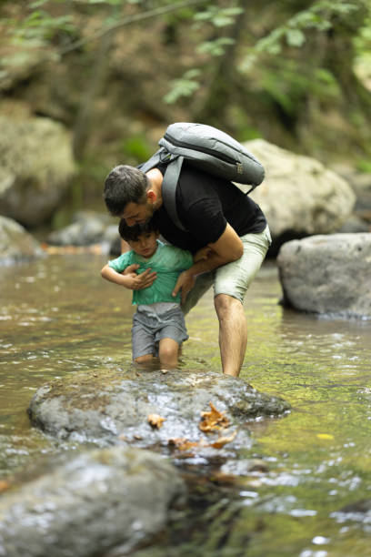 istock Father and boys hiking in the forest 1730220471